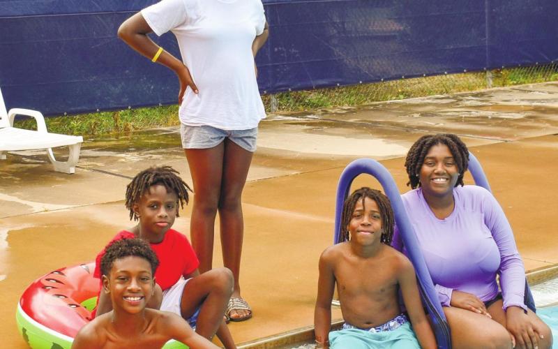 Posing for the photo at the Putnam County swimming pool are, left to right, middle schoolers Jacob White, Bryce Leslie, Harmony Swimey, Rasha Ellison, and camp instructor Rakeena Griffin.