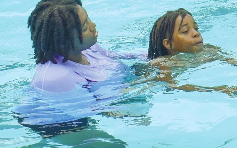 Camp instructor Rakeena Griffin gives instructions to sixth-grader Rasha Ellison.