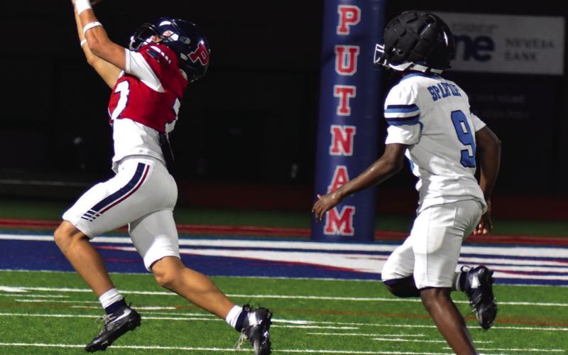 Wideout Elijah Kelly is able to reach out and pull in a pass from quarterback Caleb Reeves in the rain last Friday night against the Glenn Hill Spartans. BRANDON PARK/Staff