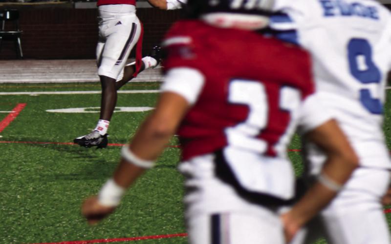 Elijah Kelley (22) looks on as Christian Lane (7) pulls in a pass from quarterback Caleb Reeves last Friday night. BRANDON PARK/Staff