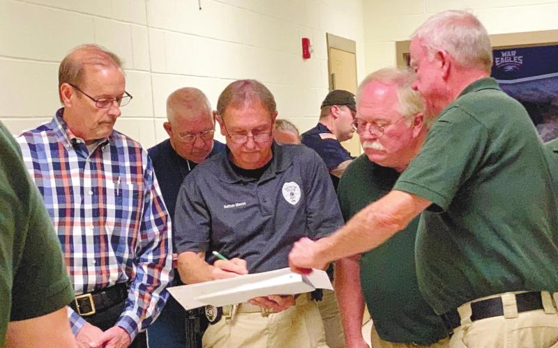 Discussing the entrances and exits of school rooms as they examine the high school’s floor plan are, from left, Eatonton Police Chief Howell Cardwell, Eatonton police Sgt. Harold “Buddy” Bowman and officer/certified instructor Nathan Mason, Putnam County Sheriff Howard Sills and Putnam County Sheriff’s Lt. Harry Luke. LYNN HOBBS/Staff