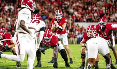 Georgia quarterback Gunner Stockton (14) in the shotgun formation, getting the offense set before a play against Alabama on Sept. 27. LANCE McCURLEY/Staff