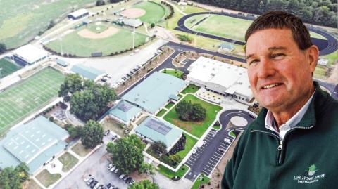 Gatewood’s Jeff Decker stands beside a large aerial photograph of the school’s 30-acre complex, much of which he had a hand in helping to develop over his nearly 13 years in Eatonton. IAN TOCHER/Staff
