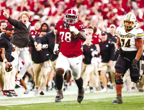 Georgia defensive lineman Nazir Stackhouse (78) returns an interception in the fourth quarter during Georgia’s game against Missouri on Dooley Field at Sanford Stadium Nov. 4 in Athens. TONY WALSH/UGA Athletics