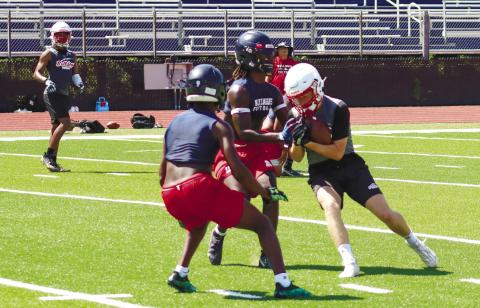A pair of War Eagle defenders stop a GMC Prep wide receiver in covering during a recent camp. LANCE McCURLEY/Staff