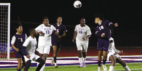 Christian Hernandez (18) floats a header over defenders. KIM CASH/Staff