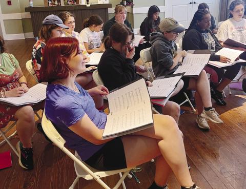 The cast of Suessical prepares for their upcoming show by practicing and reviewing their scripts as a group. CONTRIBUTED