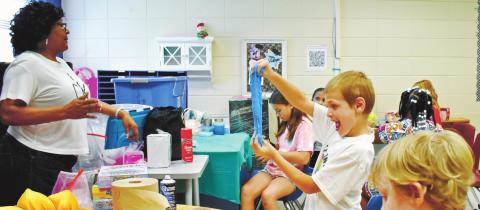 Mason Twortoer, left, and Logan Thomas are excited to play with their slime. LENA HENSLEY/Staff