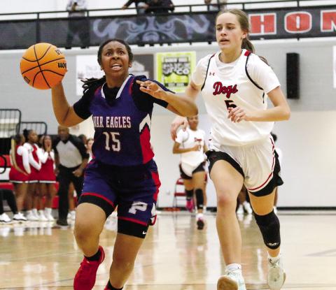 Putnam County guard Melody Richardson (15) drives past Morgan County’s Sadie Green as she tries to make an easy basket. LANCE McCURLEY/Staff