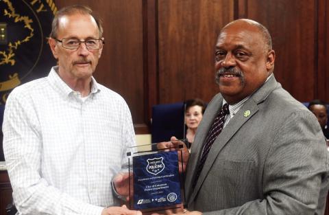 Eatonton Police Chief Howell Cardwell, left, accepts the award by Georgia Municipal Association from Eatonton Mayor John Reid. IAN TOCHER/Staff