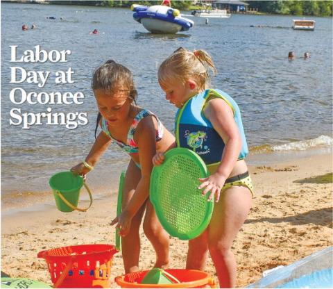 Paisley G. and Harper F. gather all their materials to build a sandcastle during Labor Day festivities at Putnam County’s Oconee Springs Park. SEE MORE PHOTOS >> PAGE B1 LENA HENSLEY/Staff