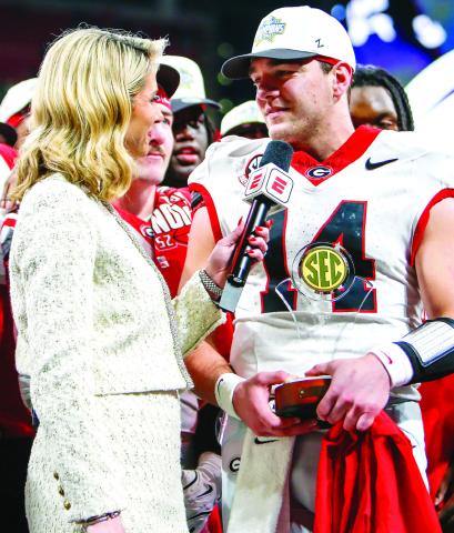ESPN reporter Laura Rutledge (left) interviews Georgia quarterback Gunner Stockton (right) following the SEC Championship game. LANCE McCURLEY/Staff