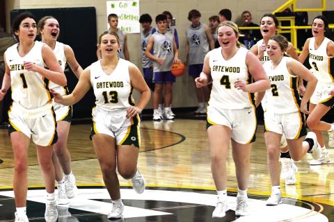 The Lady Gators, including Lauren Paxson (1), Avery Hill (13), Lily Huskins (4), Sylvie Huskins (2), and Riley Roberts (3) run off the court following a recent win in Eatonton. IAN TOCHER/Staff