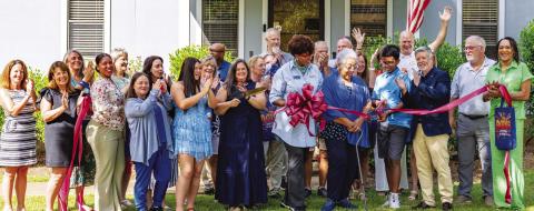 Employees and supporters of Seniors Helping Seniors Mid-South Georgia cheer as the ribbon is cut late last Tuesday to officially recognize the opening of the unique, new facility in Putnam County. CONTRIBUTED