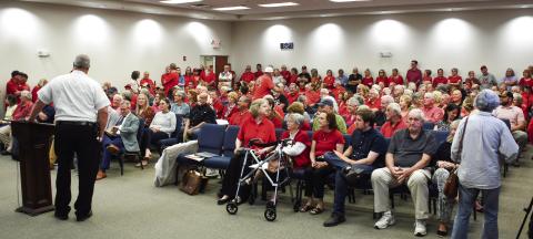 Putnam County Fire Chief Thomas McClain stands beside the podium after he delivered the news that up to 40 citizens attending a Planning &amp; Zoning meeting had to wait outside the large room at the county’s administration building. IAN TOCHER/Staff
