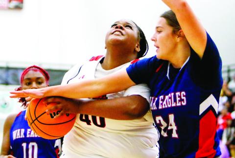 Putnam County’s Kindall Ward (24) tries to prevent Morgan County’s Breniyah Anderson (40) from taking a shot inside the paint. LANCE McCURLEY/Staff