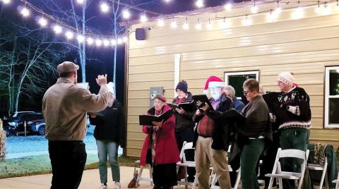 The Milledgeville Singers Club performs carols outside of the Holiday Market. BAILEY BALLARD/Staff