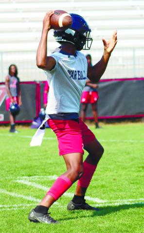Quarterback Jamarion Robertson drops back for a pass at Morgan County's passing camp last week. LANCE MCCURLEY/Staff