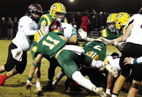 Mason Sinclair (11) makes the stop on a Briarwood ball carrier, aided by seniors Blake Callaway (5) and Evan Bennett (7). ARELLA CASH/Staff
