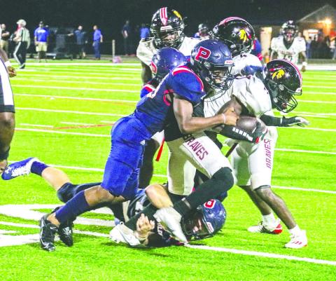A Putnam County tackler brings down Baldwin wide receiver Armontae Palmer in last year’s game at Al Reaves Field. FILE PHOTO