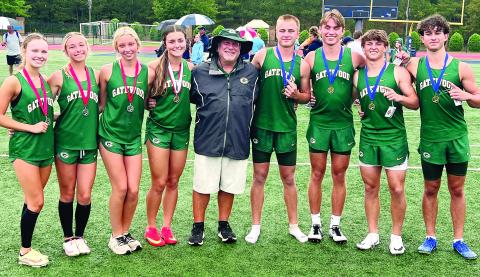 Gatewood track-and-field head coach Jeff Ratliff stands between his third-place girls 4X100 relay team and the record-setting boys 4X400 relay team at the 2025 GIAA 3A State Track &amp; Field Meet. CONTRIBUTED