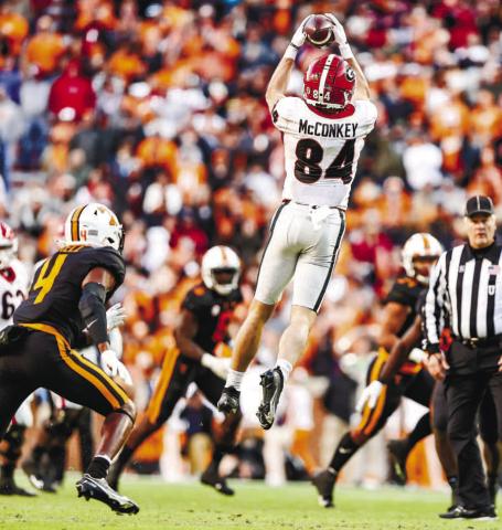 Wide receiver Ladd McConkey (84) goes up and makes a catch between multiple Tennessee defenders in last year’s game against the Volunteers. TONY WALSH/UGA Athletics