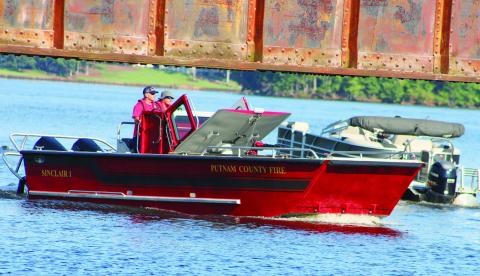 Putnam County Fire Department’s personnel scan the lake from “Sinclair 1” searching Lake Sinclair with other agencies for the missing jet ski rider. LYNN HOBBS/Staff