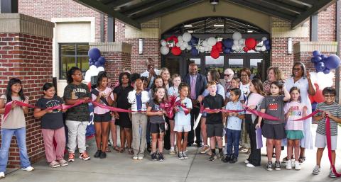 Along with several Putnam County Elementary School students at the ribbon cutting, Putnam County Board of Education Superintendent Derick Austin (center, pink tie) was joined by BOE board members Charles Trumbo (left, back row), BOE Chair Dr. Steve Weiner (sunglasses), and (l-r, back row,) Doris Clemons, Carol Ann Guthrie, and Rev. Simone Jones. PCES Principal Whitney Smith is standing to Austin’s right. IAN TOCHER/Staff