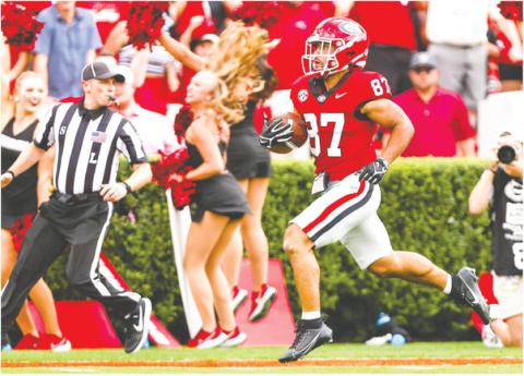 Mekhi Mews (87) breaks away from Ball State defenders during a 69-yard punt return, which sparked the Bulldogs to score 45 unanswered points. TONY WALSH/UGA Athletics