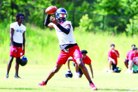 Putnam County senior quarterback Jamarion Roberton sits in the pocket, preparing to fire a pass across the field during Tuesday’s practice. (LANCE MCCURLEY/Staff)