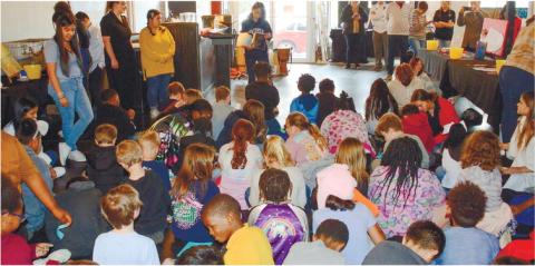 Putnam High students line the edges of the room at the Live and Drive Book Fair they organized and presented March 10, at Georgia Writers Museum.