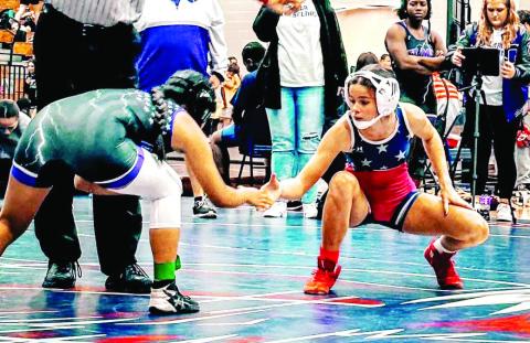 Putnam County’s Lily Frisch (right) shakes hands with a competitor. ARELLA CASH/Staff