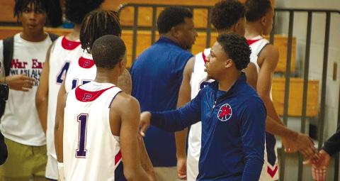 Nick Banks (right) talks to his brother Eren (left) during a timeout of a home game last season. CONTRIBUTED