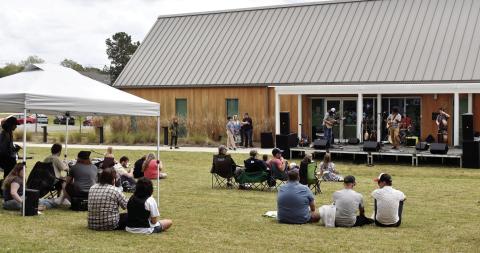 Colin Cutler and Hot Pepper Jam, of GCSU’s Music Department, Sally Jaye, and special guest Rob Sumowski played throughout the day on the stage set up in front of Andalusia Farm’s Interpretive Center. Attendees brought tents, blankets, and chairs to enjoy the day's festivities. BAILEY MCCULLY/Staff