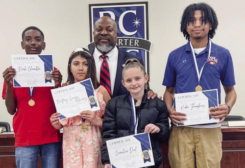 L-R: Students Noah Chamblee, Brittany Suazo Alvarez, Caroline Dial, and Kaden Thompkins received February Student of the Month certificates and swag bags from Putnam County School Superintendent Derick Austin. IAN TOCHER/Staff