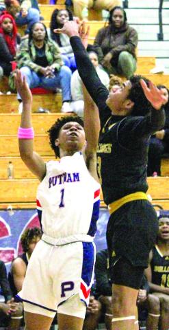 Putnam County freshman Jeremy Banks (1) goes up for rebound against Thomson guard in last Tuesday’s loss to the No. 1 Bulldogs. TREY NORRIS/Staff