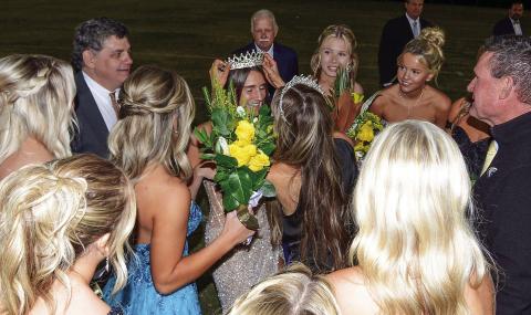 Backed up by her dad Jeff Mansfield and surrounded by senior classmates, 2024 Gatewood Homecoming Queen Sarah Mansfield is crowned by last year’s queen Taylor Moreno, with Gatewood Head of Schools Jeff Decker (right) looking on. IAN TOCHER/Staff