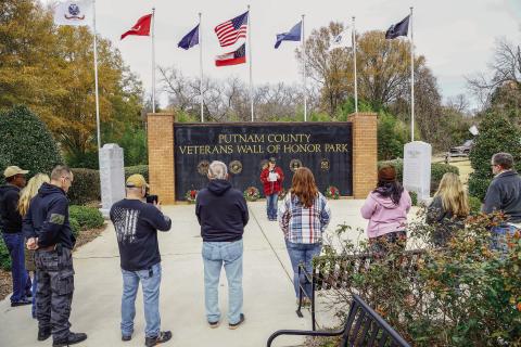 Standing in front of the Putnam County Veterans Wall of Honor, VFW Commander Nikki Barker addressed a small but dedicated group of volunteers on Wreaths Across America Day last Saturday. JOHN BETANCOURT/Contributed