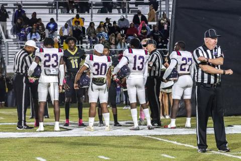 Jalon Kilgore (23), Kemarion Griffin (30), Mark Little (13) and Tamarion Peters (27) act as captains for Putnam County and meet at midfield with players from Thomson. LANCE MCCURLEY/Staff