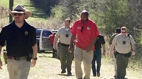 JCSO Lt. Kenny Gleaton (l-r) PCSO deputy Jim Barbee, Putnam Deputy Coroner Andre Williams, PCSO Deputy Paul Bernichon and other Jones and Putnam authorities walk back to their vehicles after recovering a body on Cedar Creek Sunday afternoon. LYNN HOBBS/Staff