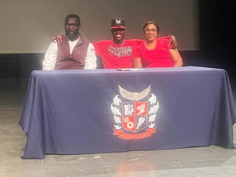 Jermaine Nelson poses between his father Brenton Nelson and mother Latoya Smalling during his signing ceremony for Thomas University. CONTRIBUTED