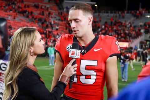 Georgia quarterback Carson Beck (15) chats with ESPN sideline reporter Molly McGrath after the Bulldogs' 51-13 win over Kentucky. LANCE MCCURLEY/Staff