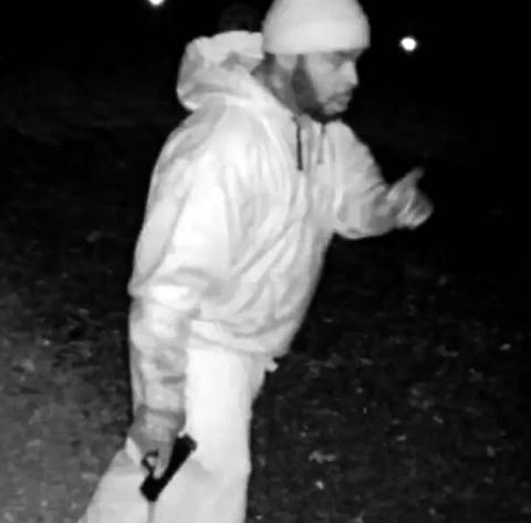 Security camera reveals an armed prowler in the yard of a River Lake Drive residence. 