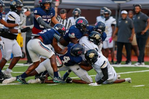 A pack of Putnam County defenders swarm a Greene County ball carrier in last week's 42-15 win over the Tigers. LANCE MCCURLEY/Staff
