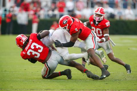 Georgia defensive lineman Quintavius Johnson (33) and linebacker CJ Allen (3) bring down an Ole Miss ball carrier. LANCE MCCURLEY/Staff
