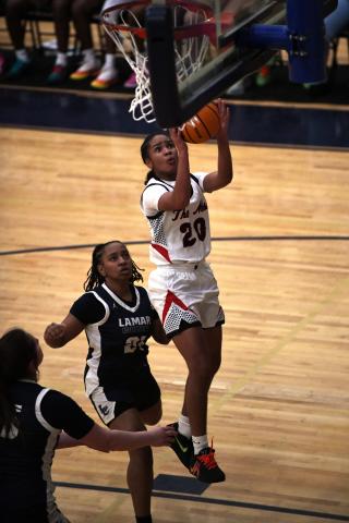 Putnam County freshman point guard Jaydah Baker (20) goes up for a layup over a Lamar County defender in a 70-56 win over the Lady Trojans on Jan. 28. Baker led the Lady War Eagles with 24 points in the win. IAN TOCHER/Staff