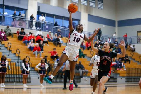 Putnam County's Journey Waller (10) goes up for a layup over a Chattooga defender. LANCE MCCURLEY/Staff