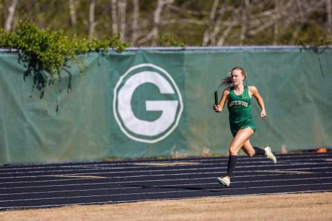 Gatewood senior Presley Moss runs her part of a relay race at a home meet earlier this season. CONTRIBUTED