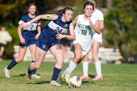 Westminster junior striker Faith Lawhead (24) dribbles the ball past Gatewood senior forward Natalie Sills (18). LANCE McCURLEY/Staff