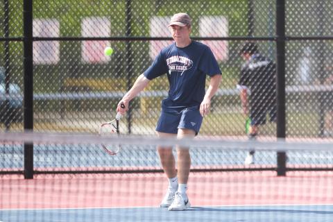 Putnam County's Leland Erickson returns a serve during a match in the region tournament in March. LANCE MCCURLEY/Staff